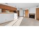 Bright living space with a fireplace, laundry, and a pass-through to the kitchen at 8701 Huron St # 5-210, Thornton, CO 80260