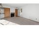 Living room with fireplace and laundry adjacent to the entry door at 8701 Huron St # 5-210, Thornton, CO 80260