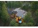 Aerial view of a home featuring mature trees and an outdoor deck with a hot tub at 2386 Daisy Ln, Golden, CO 80401