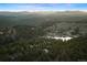 Breathtaking aerial view of the community, showcasing the homes, lake, and mountain range at 2386 Daisy Ln, Golden, CO 80401