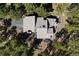 Stunning aerial view of a home nestled within a dense forest, showcasing the roofline and surrounding landscape at 2386 Daisy Ln, Golden, CO 80401