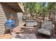 Inviting back deck featuring a grill, a hot tub, outdoor seating, and lush greenery, perfect for relaxation at 2386 Daisy Ln, Golden, CO 80401