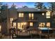 Back exterior view featuring an expansive deck, hot tub, a balcony, and outdoor seating under a twilight sky at 2386 Daisy Ln, Golden, CO 80401
