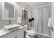 Bright bathroom features white vanity, shower and bath tub combo at 2386 Daisy Ln, Golden, CO 80401