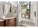 Bright bathroom features a granite vanity, soaking tub, and large window at 2386 Daisy Ln, Golden, CO 80401