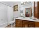 Bathroom with a wood vanity, window, bath tub and shower combination at 2386 Daisy Ln, Golden, CO 80401