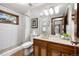 Updated bathroom showcasing a tiled shower, a wooden vanity, and a well-lit mirror at 2386 Daisy Ln, Golden, CO 80401