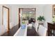 Bright dining room with seating for six and view into the living room with vaulted ceilings at 2386 Daisy Ln, Golden, CO 80401