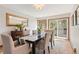 Bright dining room features a wood table, modern chairs, and access to the outdoor deck through glass sliding doors at 2386 Daisy Ln, Golden, CO 80401
