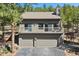 Two-story home featuring a garage, balcony, and views of the surrounding landscape at 2386 Daisy Ln, Golden, CO 80401