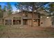 Charming home featuring stone accents, wood siding and a front yard with mature trees at 2386 Daisy Ln, Golden, CO 80401
