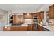 Kitchen with stainless appliances, a large island with cooktop, and natural wood cabinetry at 2386 Daisy Ln, Golden, CO 80401