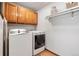 Laundry room with washer, dryer, wood floors, and cabinets at 2386 Daisy Ln, Golden, CO 80401