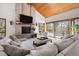 Spacious living room with brick fireplace, high ceiling, and sliding glass doors to the outside at 2386 Daisy Ln, Golden, CO 80401