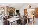 Inviting living room featuring a stone fireplace, vaulted ceilings, and cozy leather seating at 2386 Daisy Ln, Golden, CO 80401