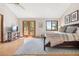 The Main bedroom boasts hardwood floors, a sliding glass door, and natural light from a door and window at 2386 Daisy Ln, Golden, CO 80401