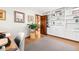 Cozy office space with hardwood floors, built-in shelving, and a view into a stairway at 2386 Daisy Ln, Golden, CO 80401