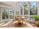 Bright sun room with a round table, wicker chairs, and a large glass door to the outside at 2386 Daisy Ln, Golden, CO 80401