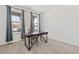 Bright office space featuring modern desk, chair, and windows with natural light and neutral gray curtains at 14842 Fairfax St, Thornton, CO 80602