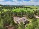 Aerial view of property featuring mature trees, open space, and a home with a hot tub at 20125 Indi Dr, Monument, CO 80132