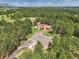Overhead view of home with red barn and forest, showing its setting and curb appeal at 20125 Indi Dr, Monument, CO 80132