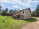Home back exterior featuring a deck, patio, and lush lawn at 20125 Indi Dr, Monument, CO 80132