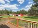 Beautiful backyard view from deck showcases outbuildings and verdant landscaping at 20125 Indi Dr, Monument, CO 80132
