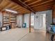 Unfinished basement space with exposed beams, wood shelving, and access to other rooms at 20125 Indi Dr, Monument, CO 80132