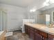 Bathroom featuring double sinks, tile floors, soaking tub, and walk-in shower at 20125 Indi Dr, Monument, CO 80132