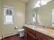 Bathroom with granite countertop, wood cabinets, tile flooring, and a big mirror at 20125 Indi Dr, Monument, CO 80132