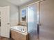 Bright bathroom features a soaking tub, glass shower, and a window with a view at 20125 Indi Dr, Monument, CO 80132