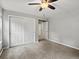 Bedroom with neutral paint and carpet features a ceiling fan, closet, and trim at 20125 Indi Dr, Monument, CO 80132