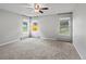 Bright bedroom featuring new carpet, neutral paint, and large windows showcasing the outdoors at 20125 Indi Dr, Monument, CO 80132