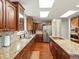 Kitchen with wood floors, stainless appliances, granite counters, and wood cabinets at 20125 Indi Dr, Monument, CO 80132
