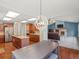 Eat in kitchen with wood floors, stainless appliances, granite counters and living room access at 20125 Indi Dr, Monument, CO 80132