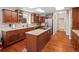 Spacious kitchen with island, wood floors, stainless appliances, and granite countertops at 20125 Indi Dr, Monument, CO 80132