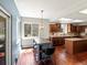 Eat in kitchen with wood floors, bar seating, stainless appliances, and granite counters at 20125 Indi Dr, Monument, CO 80132