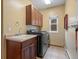 Bright laundry room featuring a sink, cabinetry, washer and dryer at 20125 Indi Dr, Monument, CO 80132