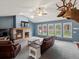 Spacious living room featuring a brick fireplace, vaulted ceiling, and natural light at 20125 Indi Dr, Monument, CO 80132