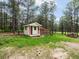 Charming shed with red door sits among the trees at 20125 Indi Dr, Monument, CO 80132