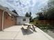 A concrete patio with picnic table and a fenced yard offers great outdoor relaxation and entertainment possibilities at 1088 Douglas Dr, Denver, CO 80221