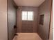 Modern bathroom featuring a bathtub, tiled walls, and natural light from a window at 1088 Douglas Dr, Denver, CO 80221