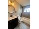 Modern bathroom featuring sleek vanity, updated fixtures, and tiled shower-tub combination at 1088 Douglas Dr, Denver, CO 80221