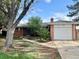 Charming single-story home with brick exterior, manicured lawn, and attached garage in a residential neighborhood at 1088 Douglas Dr, Denver, CO 80221