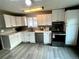 Well-lit kitchen featuring white cabinets, stainless steel appliances, and modern fixtures at 1088 Douglas Dr, Denver, CO 80221