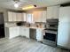 Modern kitchen with white cabinets, stainless steel appliances, and sleek countertops at 1088 Douglas Dr, Denver, CO 80221