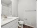 Clean, well-lit bathroom with a white vanity, toilet, and shower with glass door at 9996 Racine St, Commerce City, CO 80022