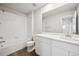 Well-lit bathroom with a shower over the tub and sleek white cabinets at 9996 Racine St, Commerce City, CO 80022