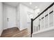 Inviting entryway featuring wood-look flooring, white walls, and an elegant staircase at 9996 Racine St, Commerce City, CO 80022