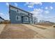Charming two-story home with a mix of gray and blue siding and a well-lit interior at 9996 Racine St, Commerce City, CO 80022